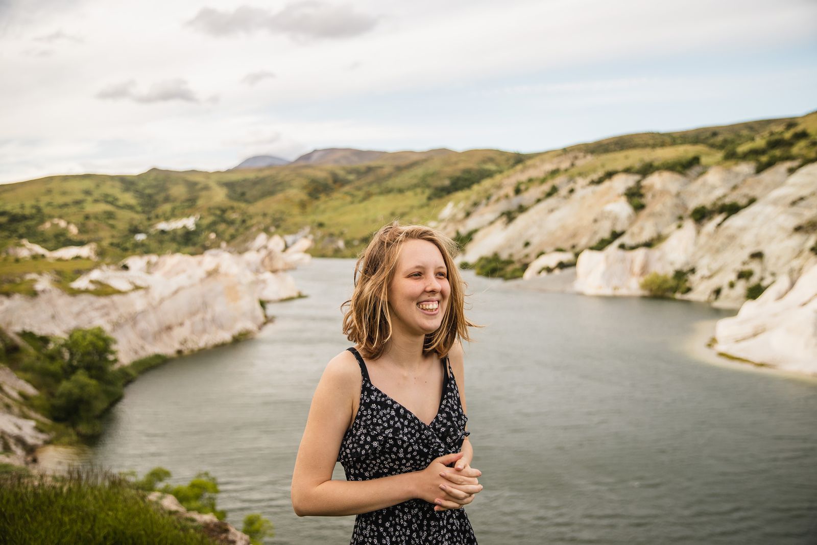 Abigail Hannah laughing beside a blue lake